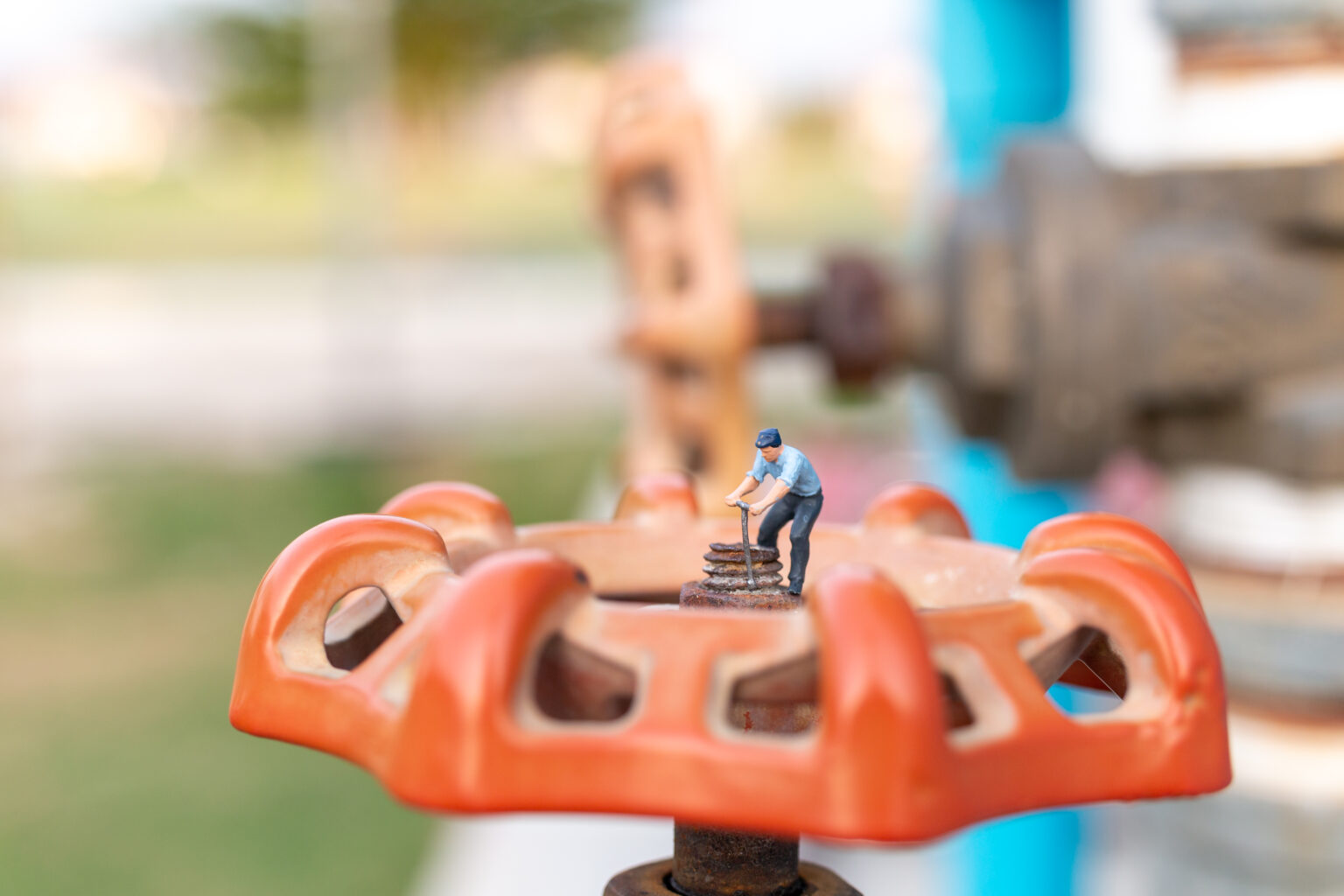 Miniature people, Working Plumbers install water pipes and check damage to water pump machines